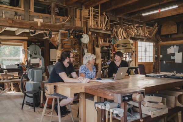 Business coach Jean Kissner, center, meets with George Sawyer and Erin Smith at Sawyer Made workshop in Woodbury. Photo by Erica Houskeeper.