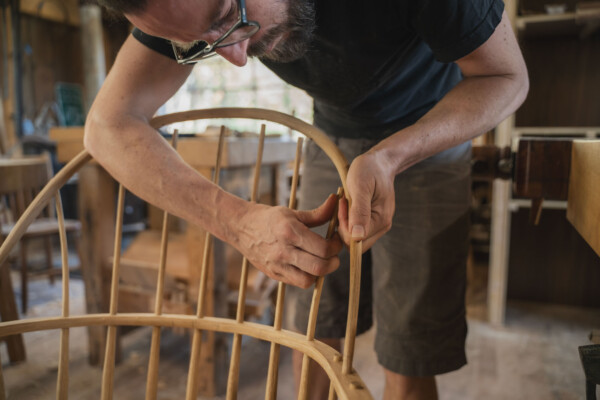 George Sawyer assembles a Windsor chair in his Woodbury workshop. Photo by Erica Houskeeper.