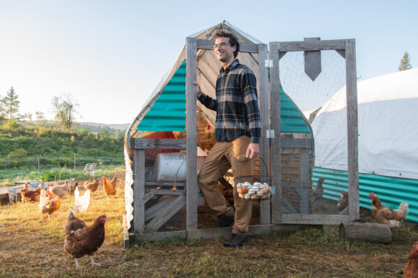 Giacomo Vascotto of Trenchers Farmhouse collects eggs from the couple’s chickens in Lyndonville. Photo by Erica Houskeeper.