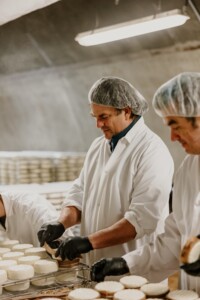 Mateo Kehler, CEO of Jasper Hill wraps cheese with locally harvested spruce bark. Photo by Hannah Natalya.